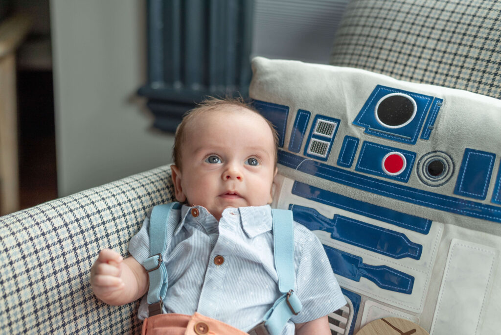 two-month old infant on R2D2 pillow