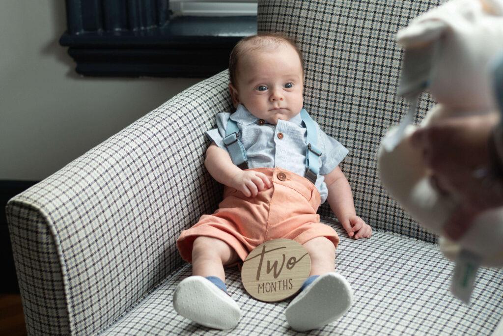 infant looking at slightly out of focus white rabbit stuffed animal