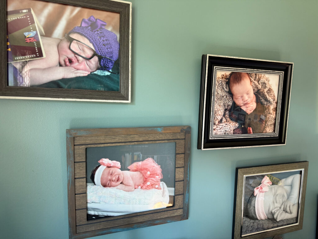 Gallery wall of newborn photos demonstrating a clear theme to the wall