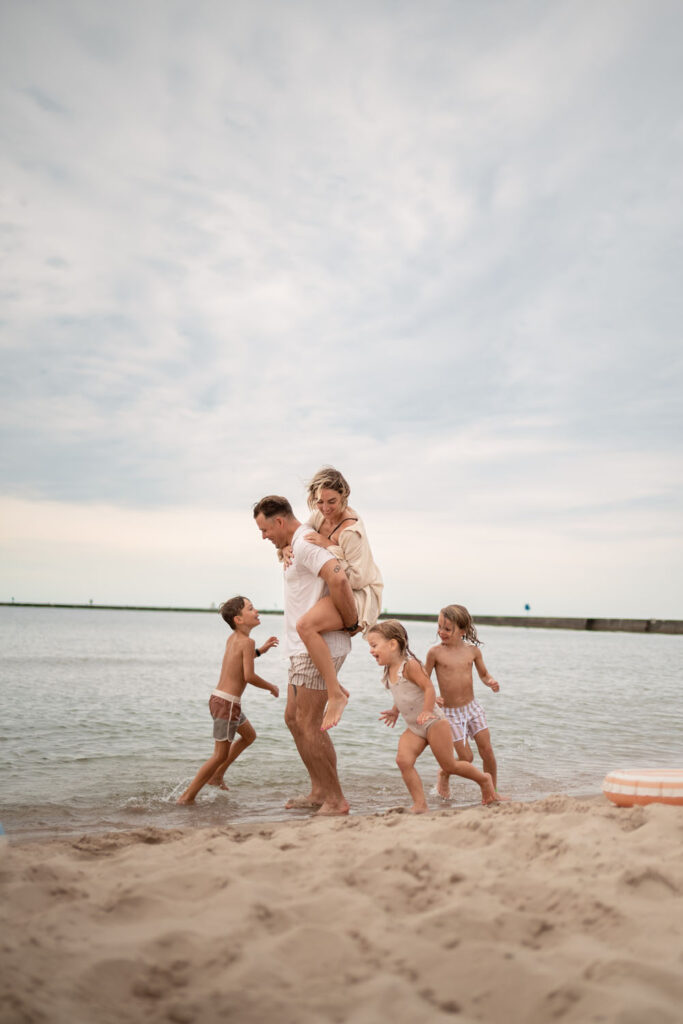Empire Family Photographer captures family playing together on the shore of Lake Michigan