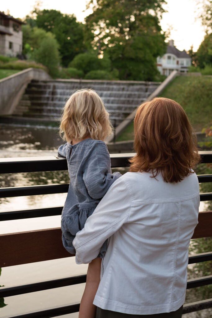 A grandmother enjoy an evening moment with her granddaughter in golden light.