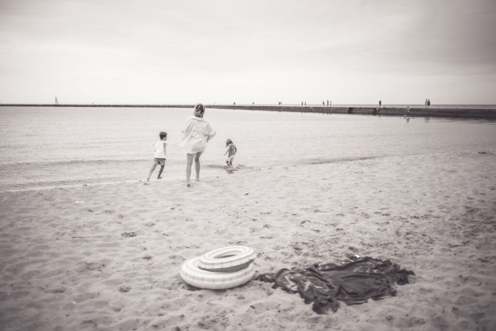 Family enjoying time together during a photo session at Frankfort Beach.