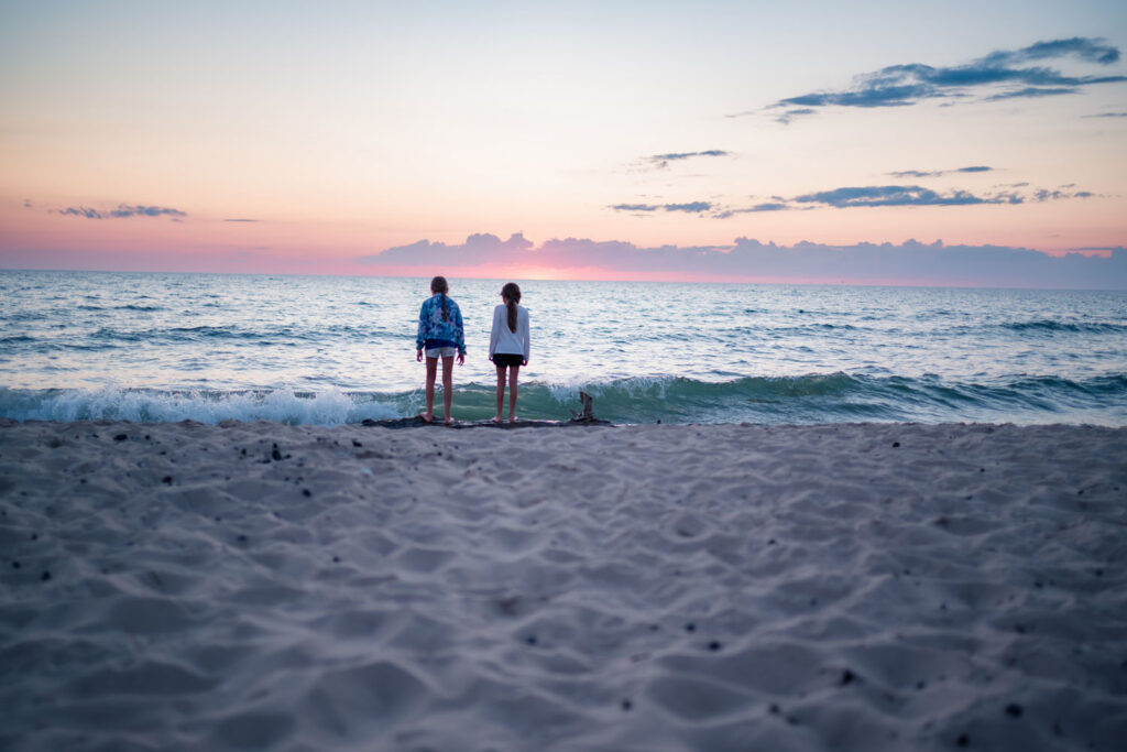 Enjoying the brilliant pink sunset during a family photo session at Esch Road Beach.