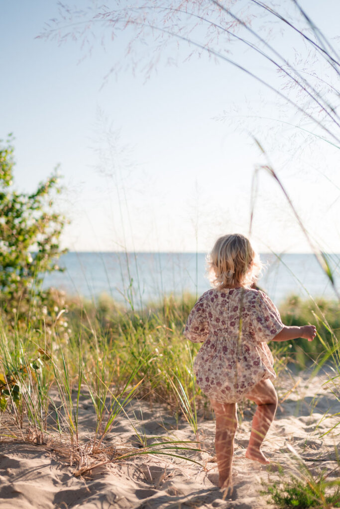 Girl exploring the dunes during an Empire Family Photography session.