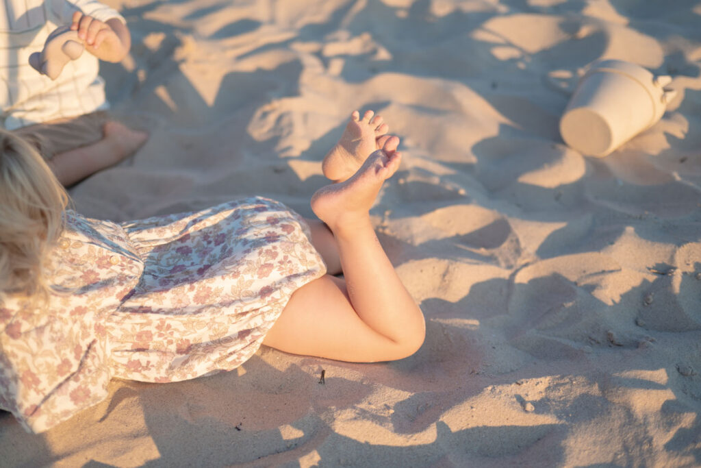 Sandy toes in the gentle morning light during a beach family photo session.