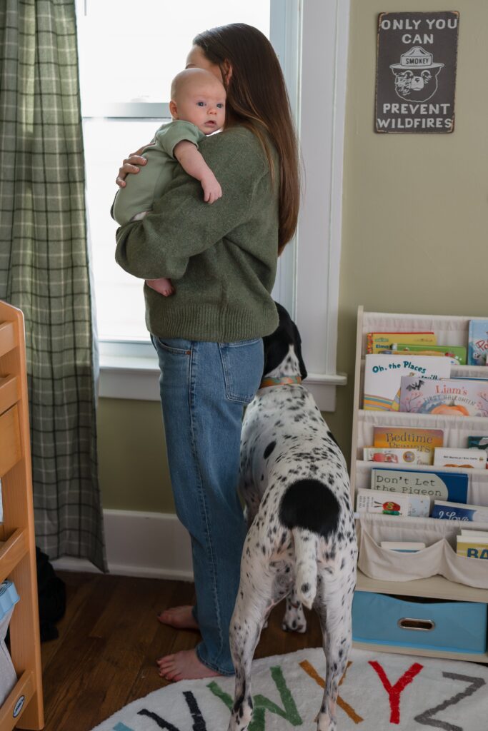 Mom in bare feet during an in-home newborn session, paired with jeans and a favorite sweater.