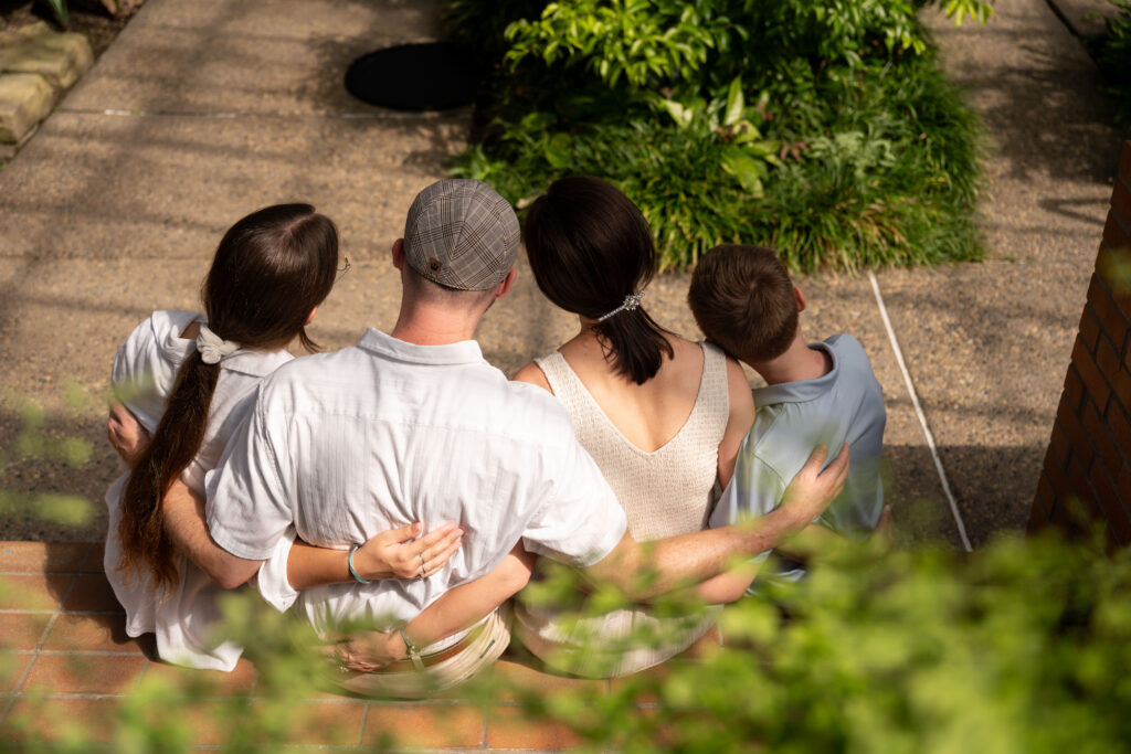 Family sitting quietly enjoying Matthaei indoor gardens.